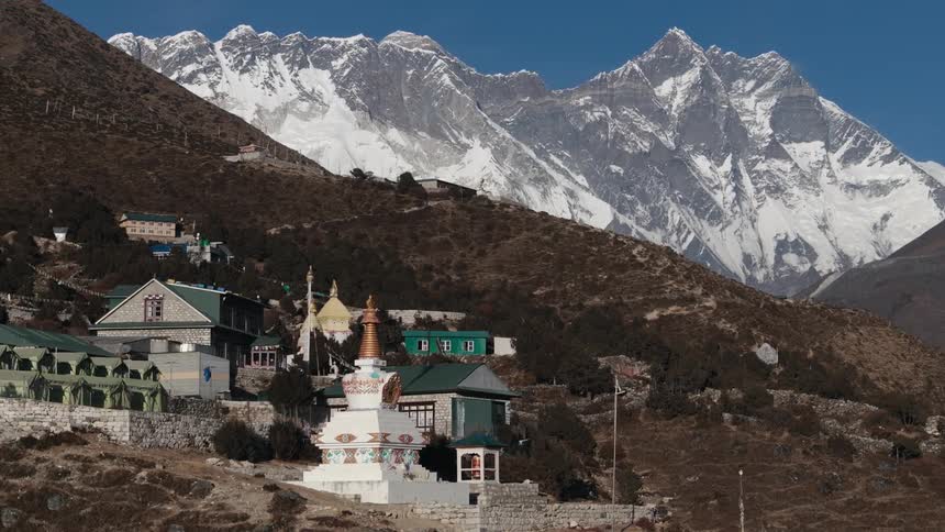 A view of some buildings in a small city up in the mountains