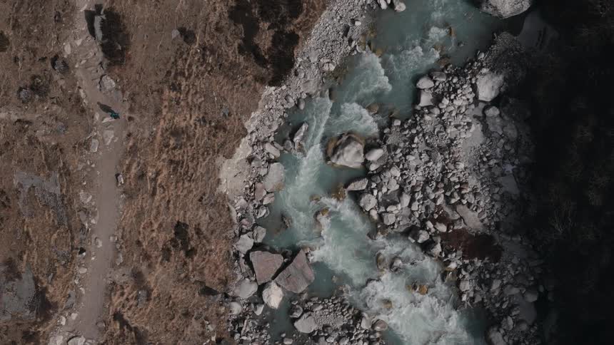 Aerial view of a flowing grayish river