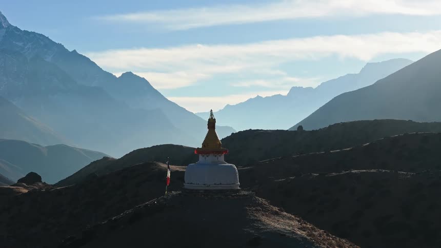 A shrine with a flag on a mountain top
