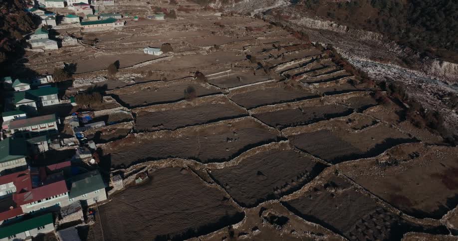 Aerial view of a village built in the middle of mountains
