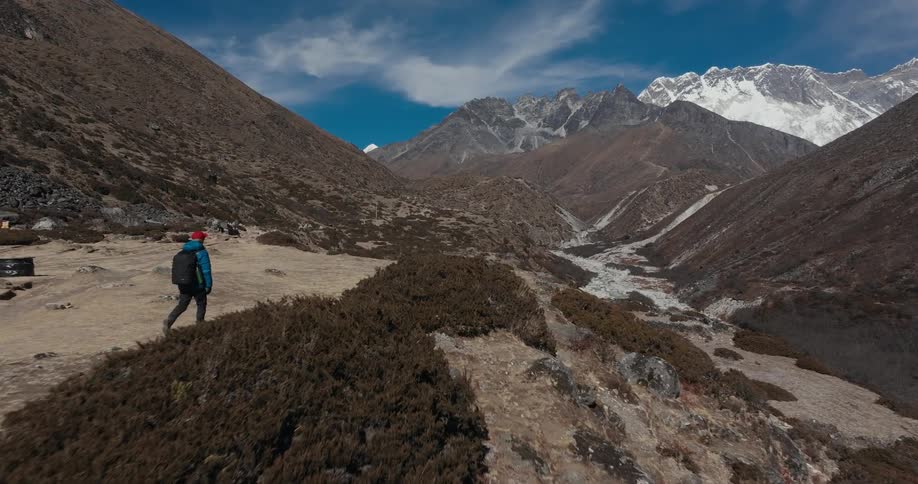 A male hiker moves across a mountain plateau