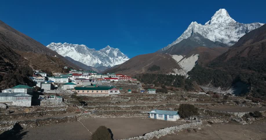 Aerial of a village in the mountains with colorful houses and buildings