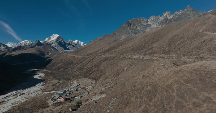 A small village sits in a mountain valley