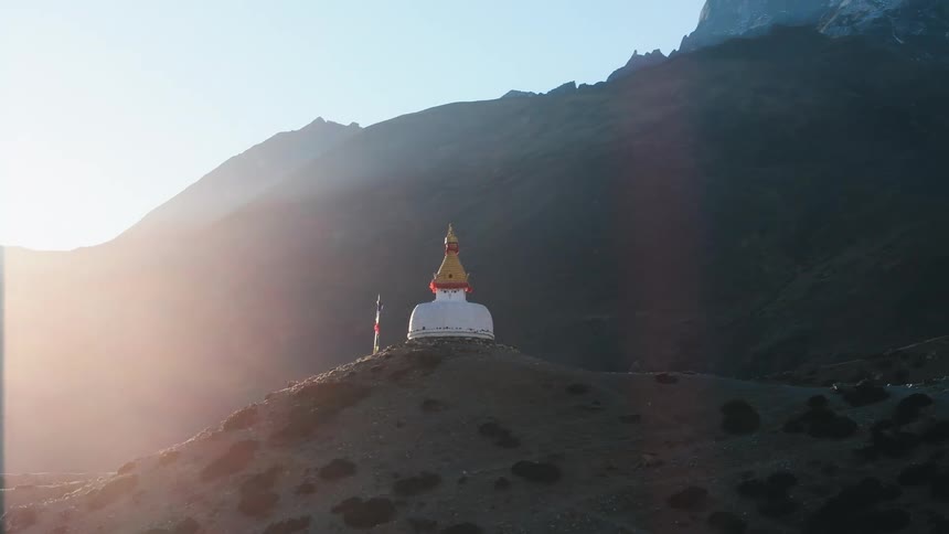 Aerial of a buddhist temple on a mountain at dawn