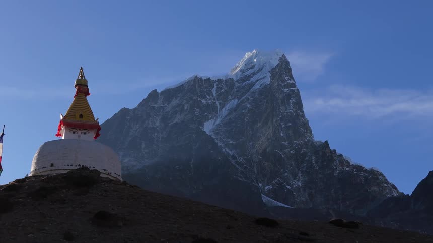 Temple on a hill surrounded by snowy mountains in winter