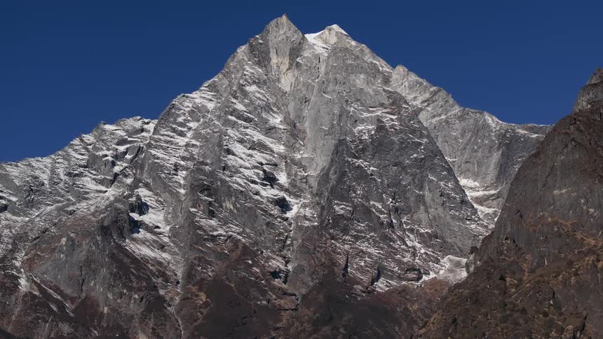 Aerial of a snowy mountain range during the day
