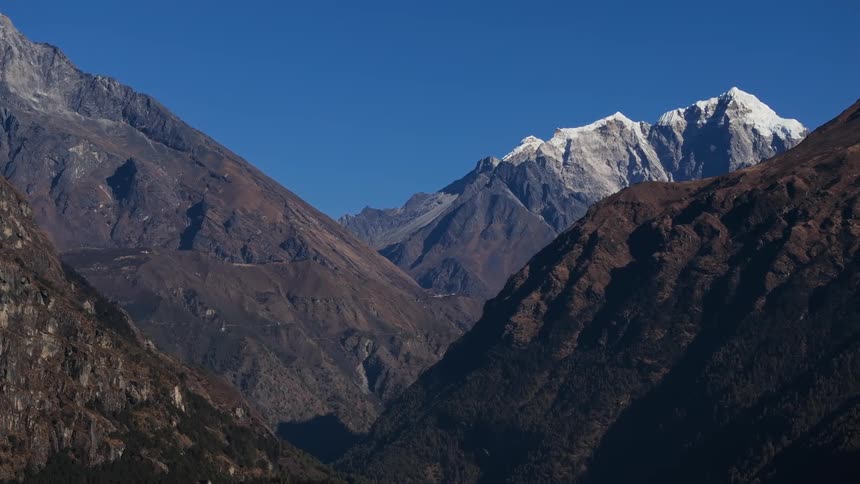 Aerial of a mountainous valley with icy mountains
