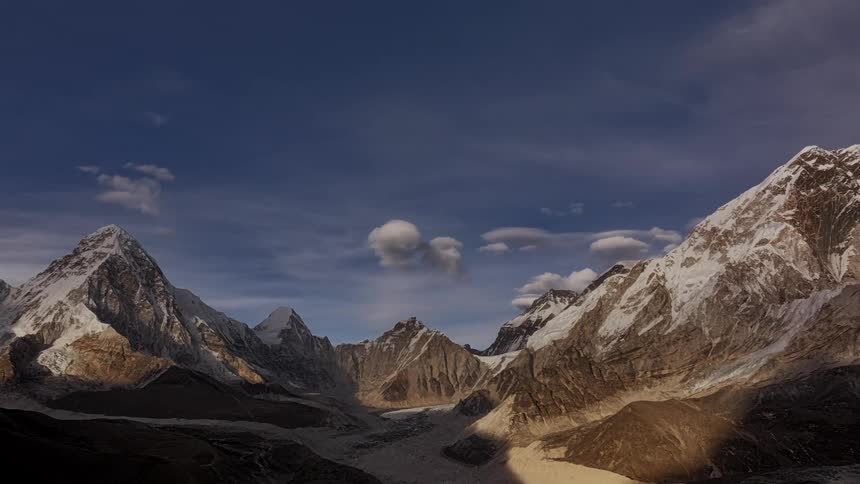 Aerial of a snowy mountain valley at sunset