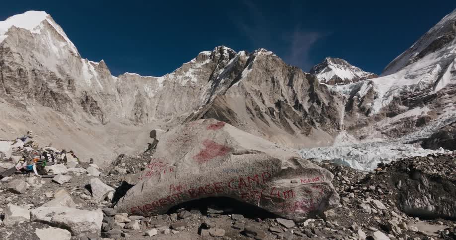 Rock with writings amidst mountain ranges in a snowy valley