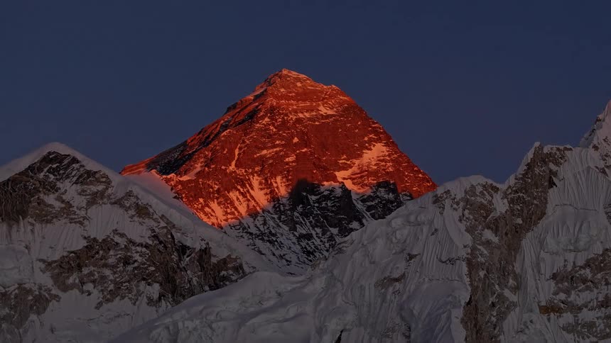 Aerial of a mountain range with ice and snow at dusk