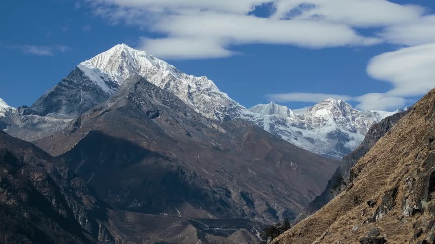 Aerial of mountain peaks with ice and snow on a sunny day