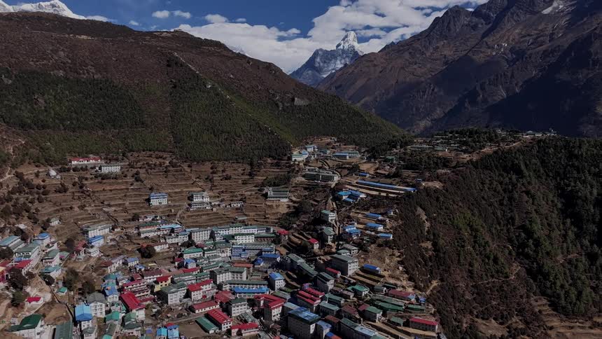 A large village on a plateau in the mountains as if all in time lapse