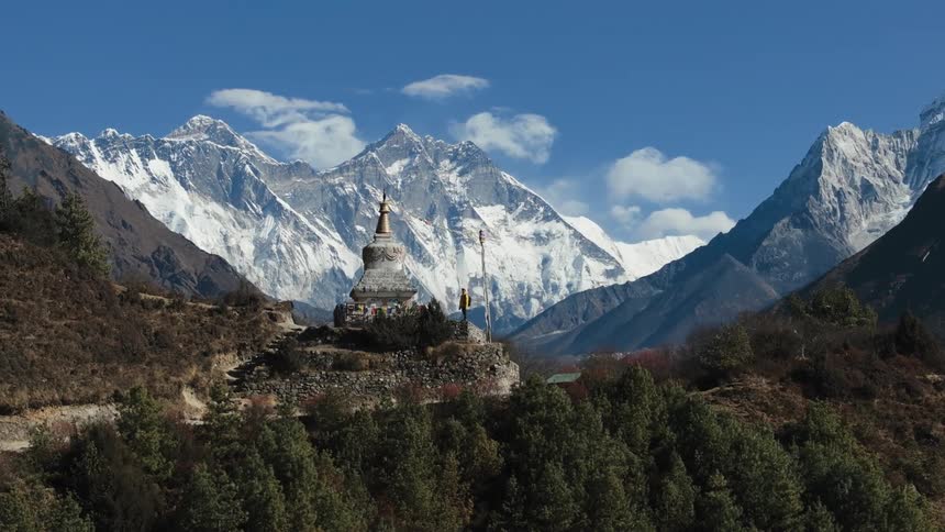 A building with a pointed shape upwards in a mountainous region with many forests