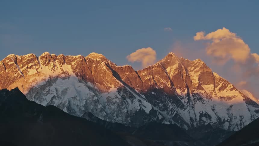 The setting sun casts its light on the peaks of the mountain range