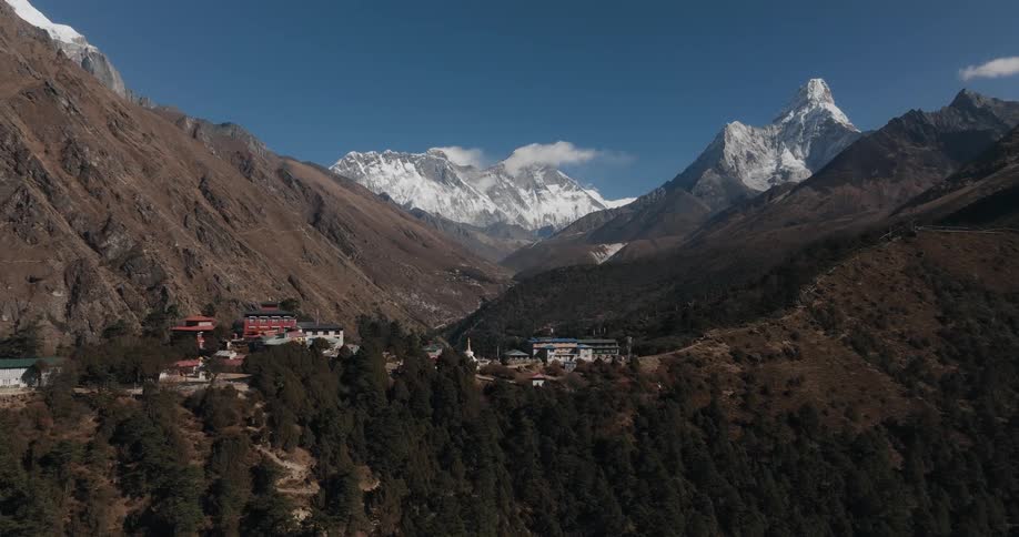 Aerial panorama of mountain ranges in a plateau village on a winter day