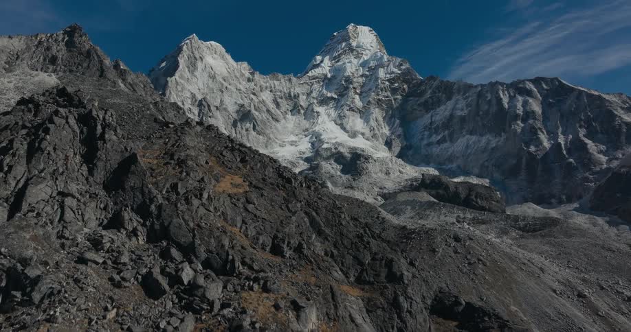 The slope of the side of an enormous mountain is covered in rocks and boulders