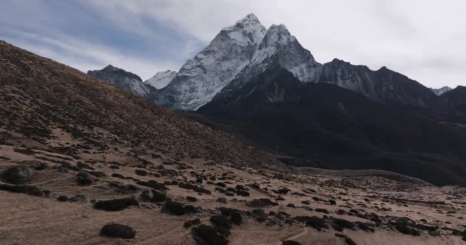 Landscape and desert soil and the fringe is a mountain with snowcapped peaks
