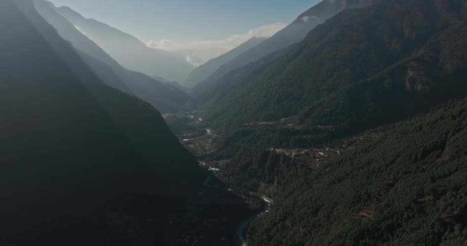 Some buildings nestled on a plateau on a mountain