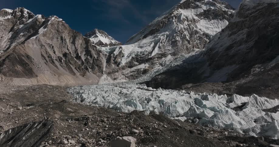 Landscape of mountains covered by snow and a dark blue sky day