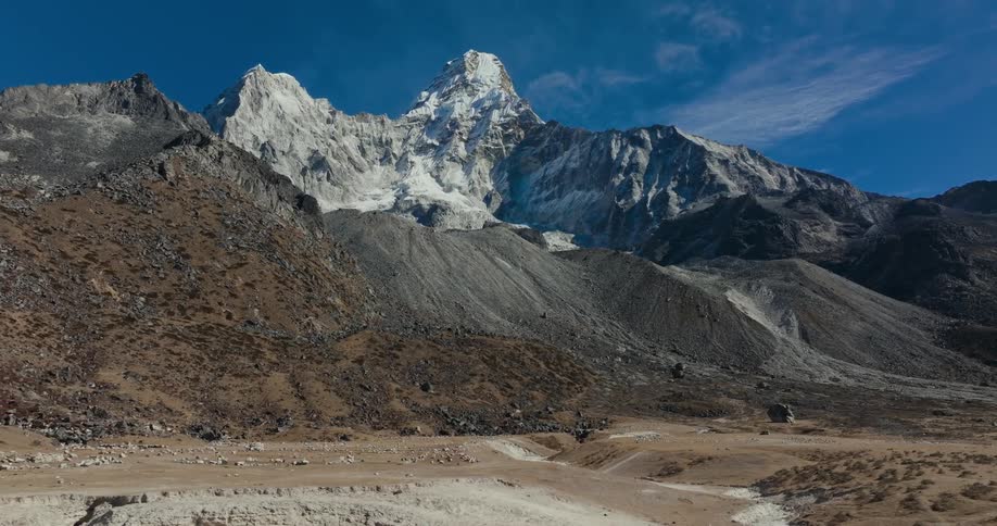 Peak of a frozen mountain in a valley on a sunny day