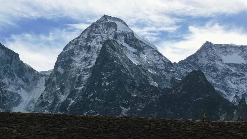 A person running on top of a mountain during a cold day