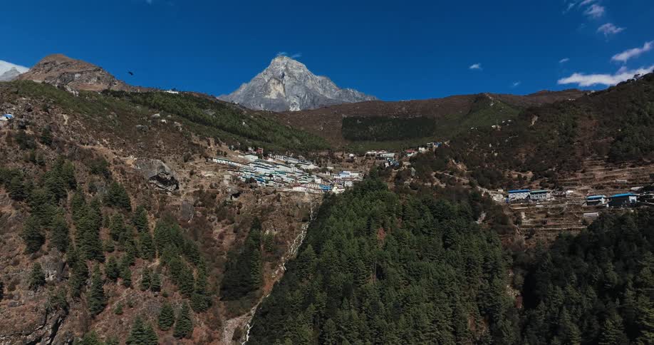 Many houses in a small town built on top of a mountain