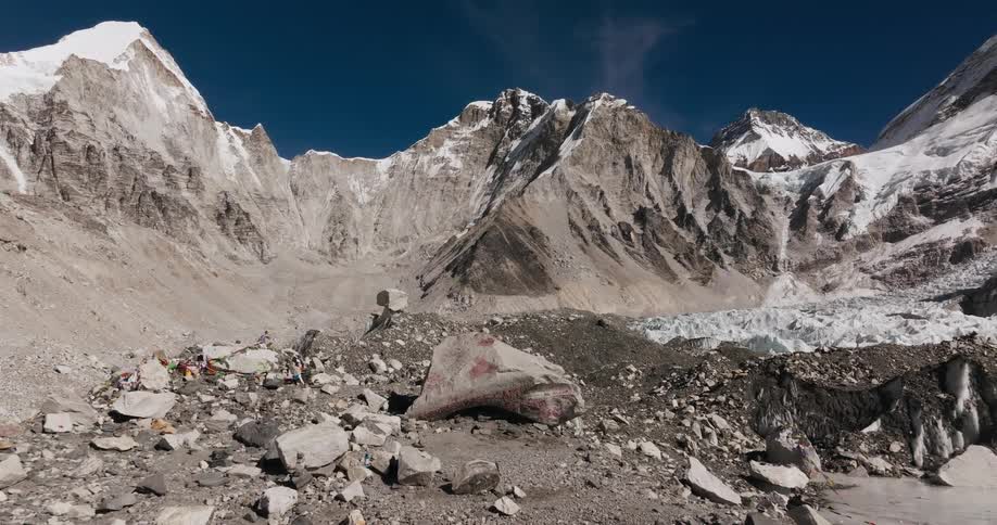 A rocky plateau at the foot of a snowy mountain range