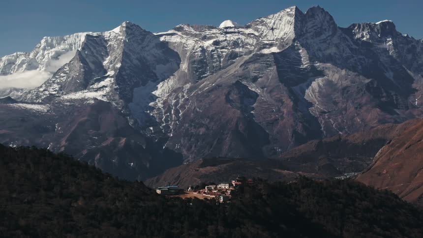 Aerial of a mountain village hidden by the forest