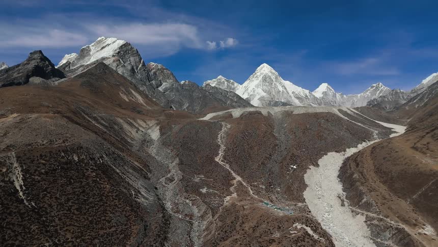 A mountainous region with stone at the bottom and snow at the top