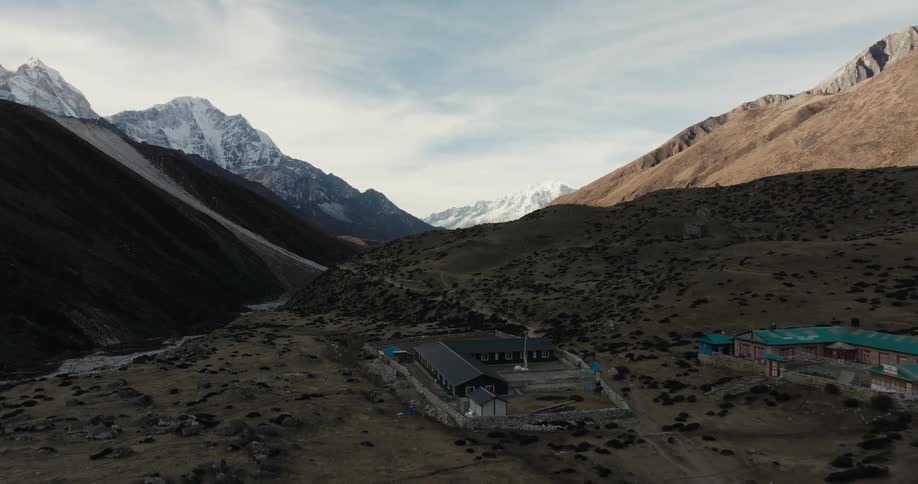 Village in a flat location on a mountain surrounded by peaks and in winter