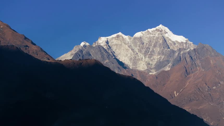 A mountain range with ice and snow on a sunny day