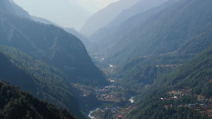 Aerial of a small village hidden between the mountains