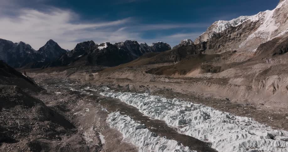 Natural landscape of a sandy soil with snow surrounded by mountains