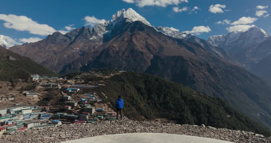 Man stood at the edge of a hill at midday after walking a bit