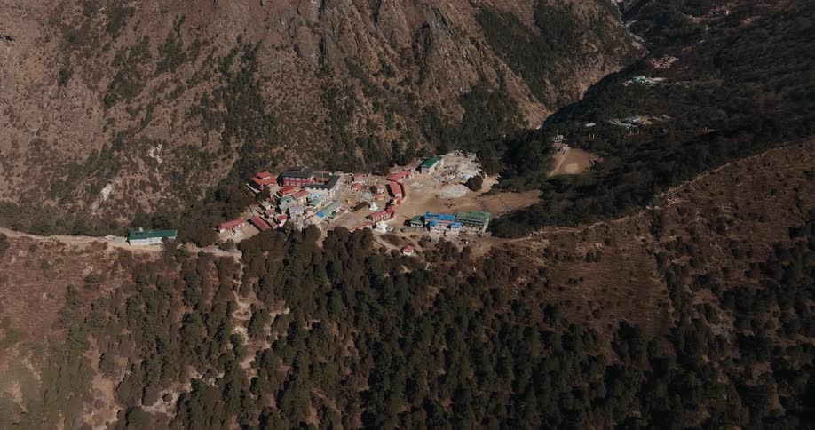 Aerial panorama of a village surrounded by mountains