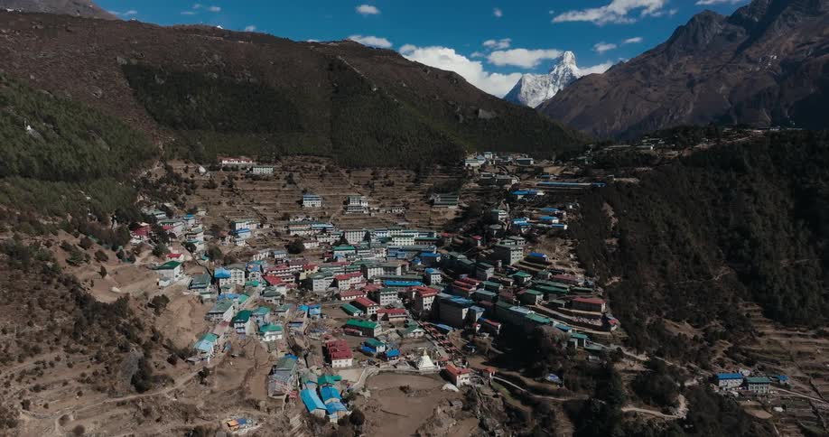 A village with many colorful houses built at the base of a mountain