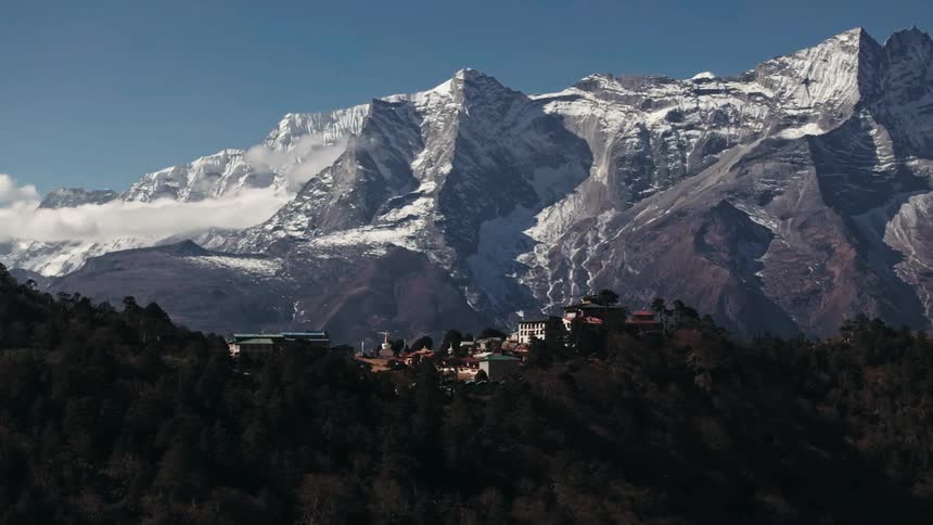 A village hidden in the wooded mountains of a wild landscape
