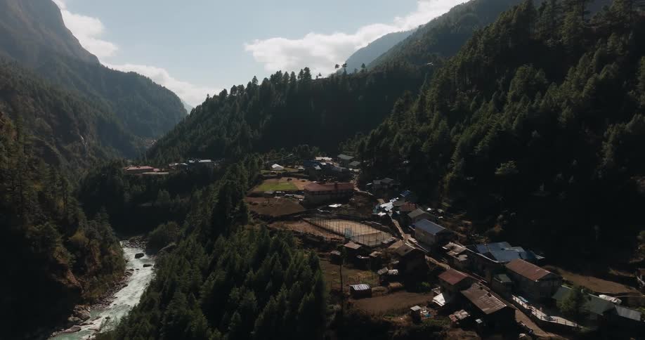 An aerial perspective captures a village nestled near a river
