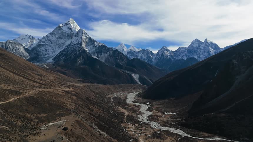 Aerial view of a mountain range with a small path in the middle of it