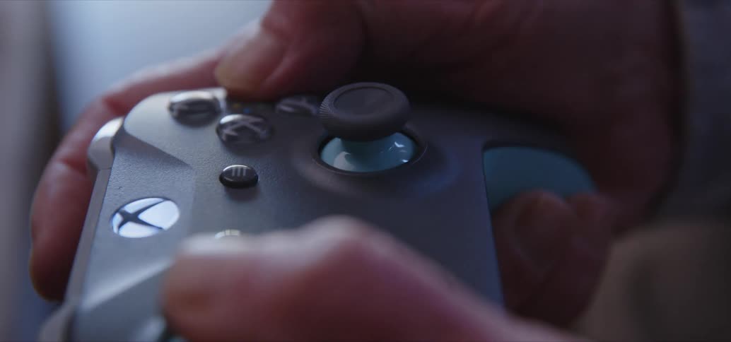 Close in the hands of a person holding an xbox controller