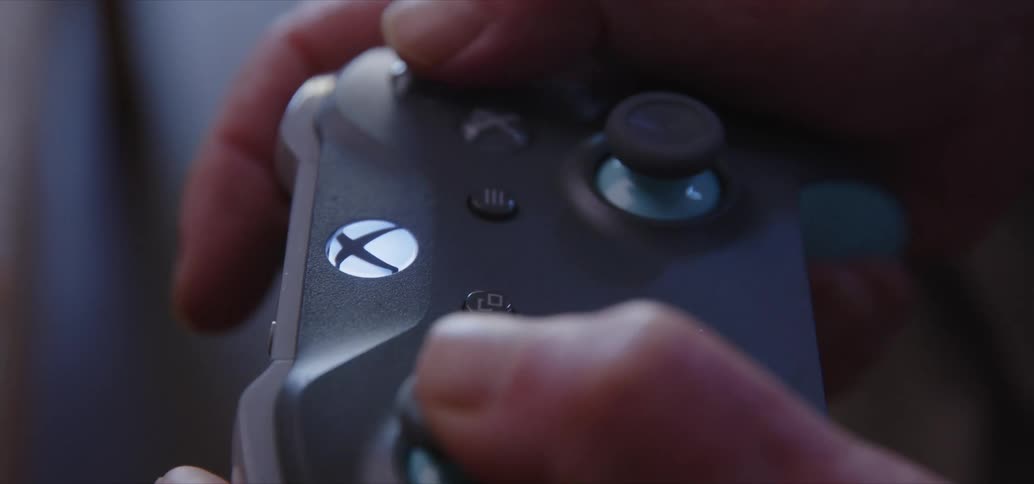 Close up of hands of a person using a video game controller