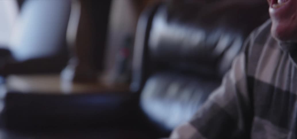 An old man laughs as he plays xbox