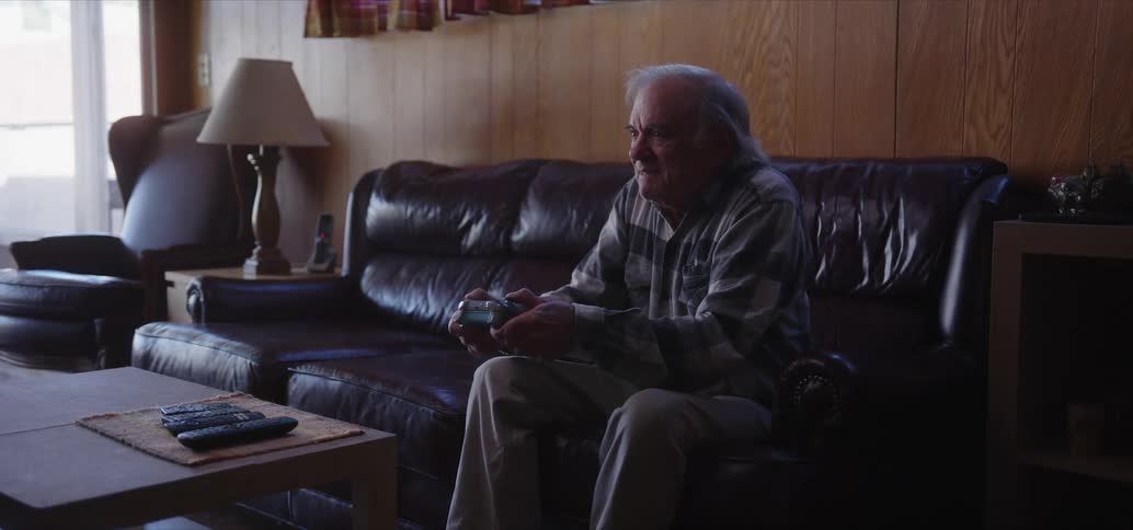 Elderly man sitting and concentrated vibrating a lot while playing video games