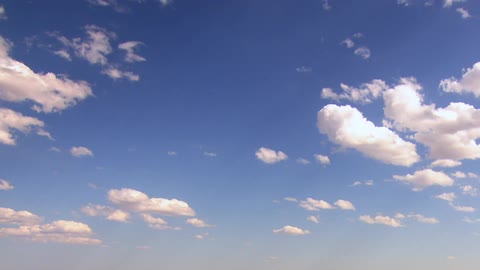 A view of the blue sky with some billowing white clouds