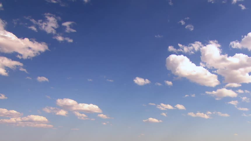 A view of the blue sky with some billowing white clouds