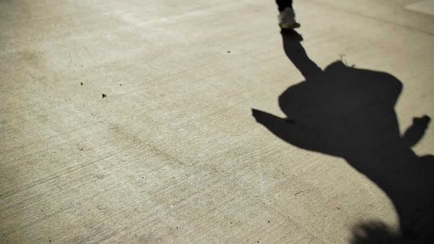 Someone dancing or spinning outside on an empty lot