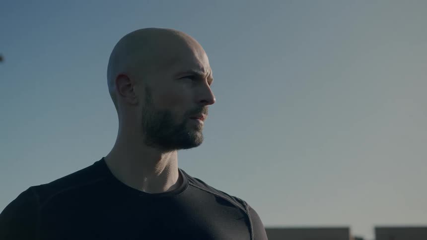A man leans forward on a sunny day