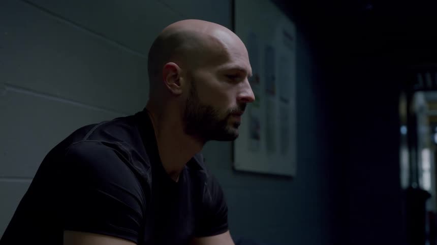 A man is sitting in the hallway