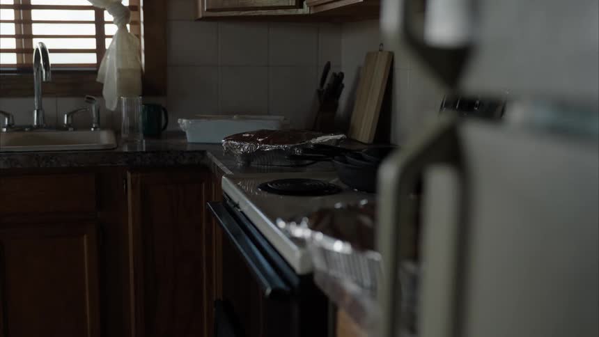 A kitchen with pans of food on a counter