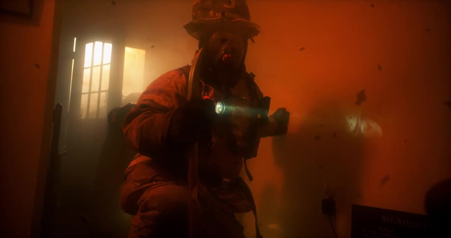 Firefighters breaking into a burning apartment